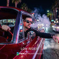 Man in sunglasses leaning out of a red car with palm trees and city lights in the background, featuring 'Low Rider' text and 'PBM AI Prompt Packs' logo.